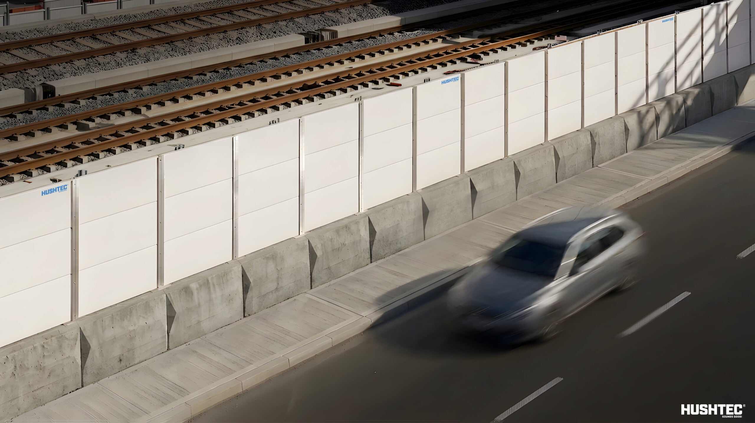 Acoustic noise barrier installed beside railway tracks to support rail and metro infrastructure operations-phase noise compliance.