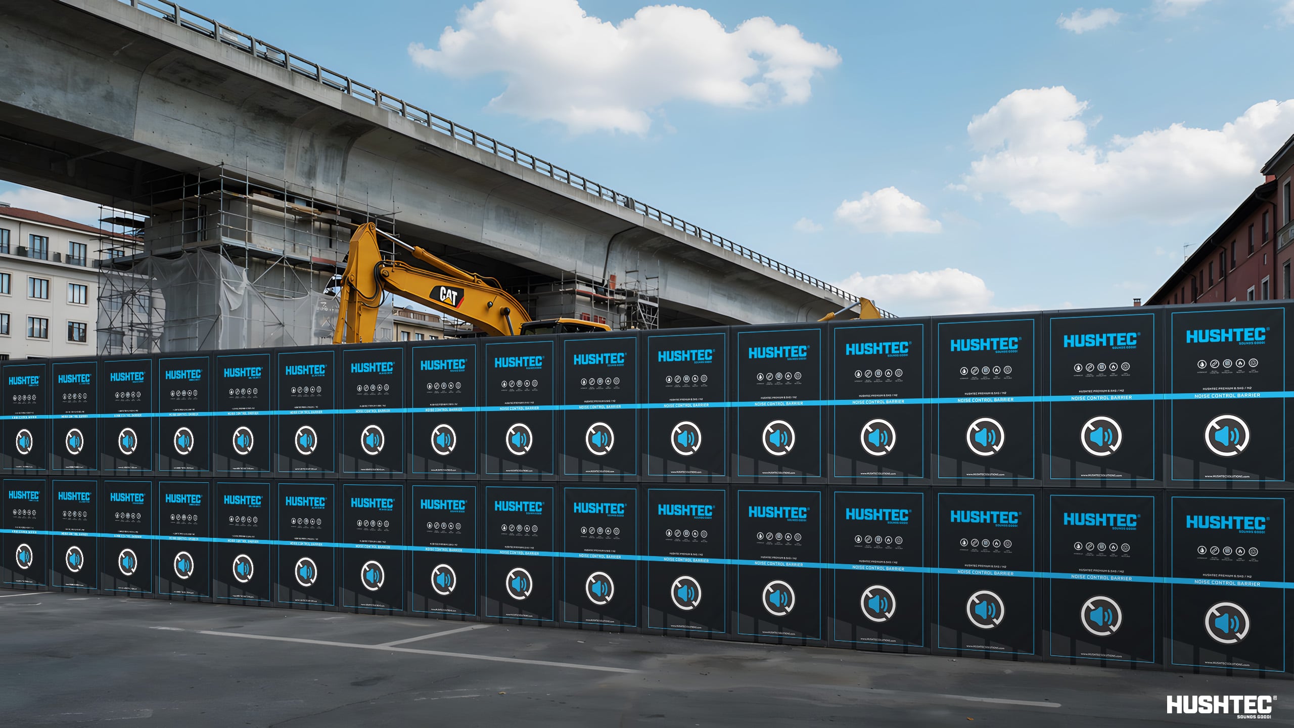 Temporary acoustic barriers surrounding an active railway construction site to reduce noise impacts on nearby communities.